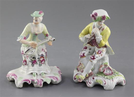 Two Derby Pale family seated figures of musicians, c.1756-9, h. 12.5cm and 12cm, restorations